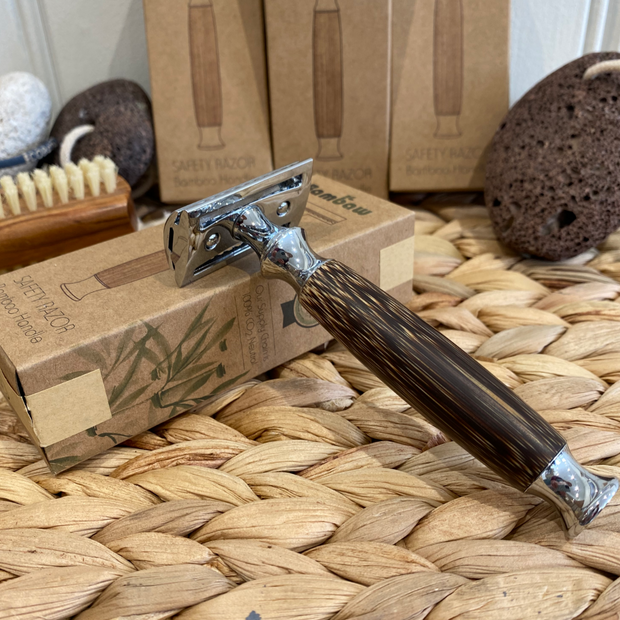 reusable bamboo and stainless steel razor on a wicker basket