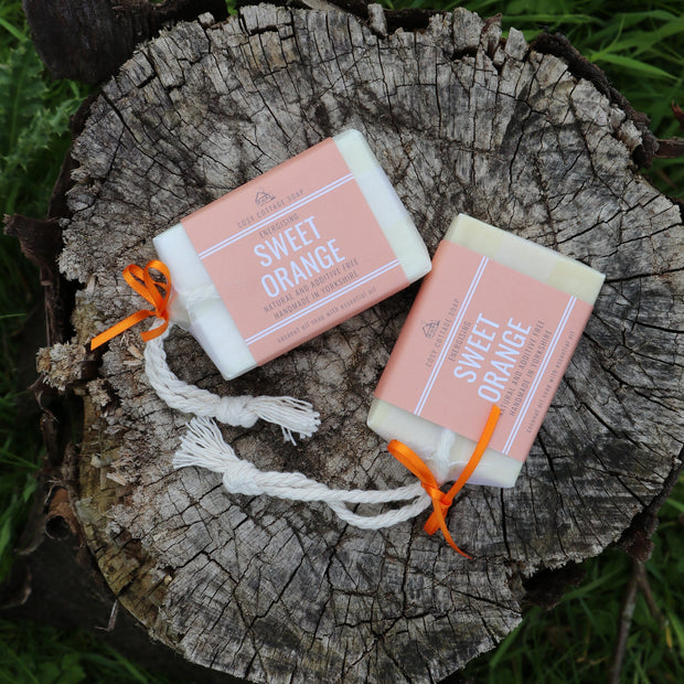 two cosy cottage soap natural soap on a rope on a log