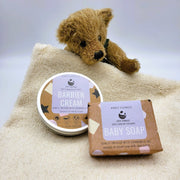 teddy bear with cosy cottage baby soap and barrier cream in a baby towel