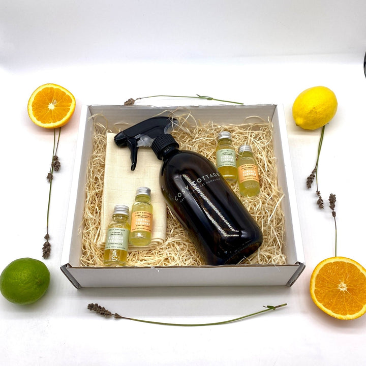 Set of cleaning spray concentrates with a spray bottle in a box  on a white background
