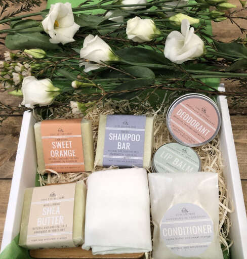 handmade soap products in a plastic free gift box with white flowers