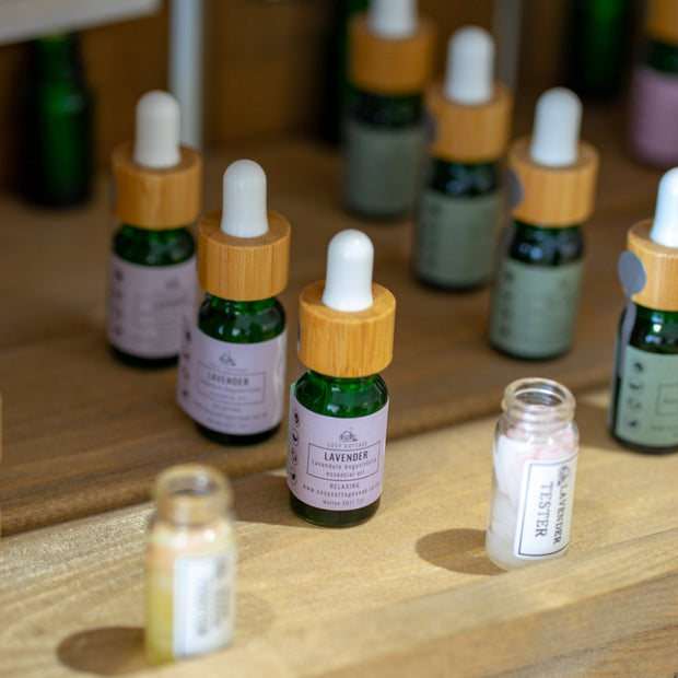 Cosy Cottage essential oils in dropper bottles  in lavender  on a wooden shelf