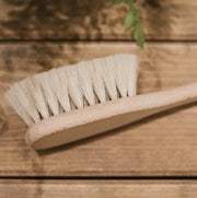 Cosy Cuddles Soft Baby brush on a wooden bench