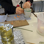 woman's hands decorating a candle jar
