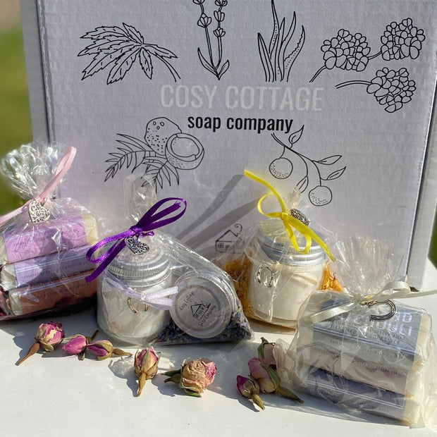 Wedding favour sample box with mini candle, mini soaps and mini lip balm all wrapped and decorated with ribbons and metal charms and dried flowers
