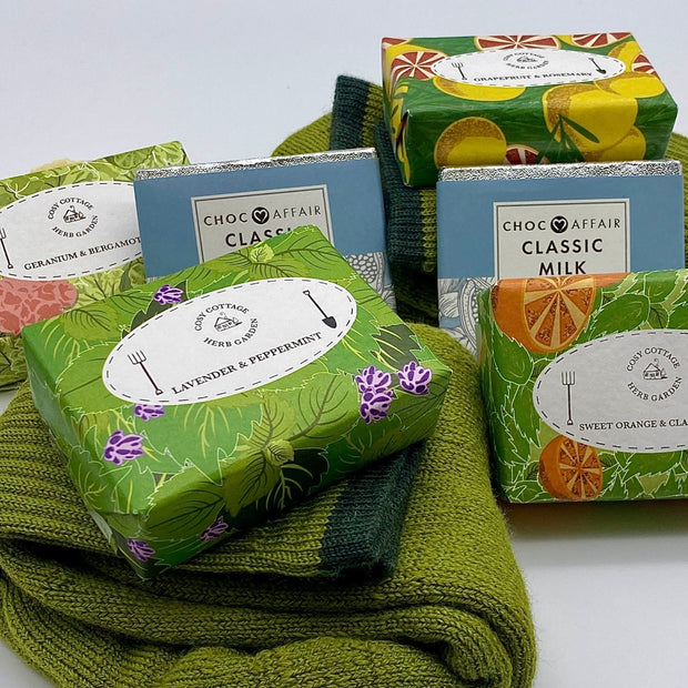 Cosy Cottage herb garden soaps with green woollen socks and 30g bar of milk chocolate 