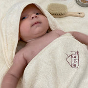 baby wearing Cosy Cuddles hooded towel