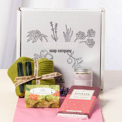 Yorkshire celebration gift box containing geranium and bergamot soap, lavender hand and body cream, rhubarb milk chocolate and green woollen socks
