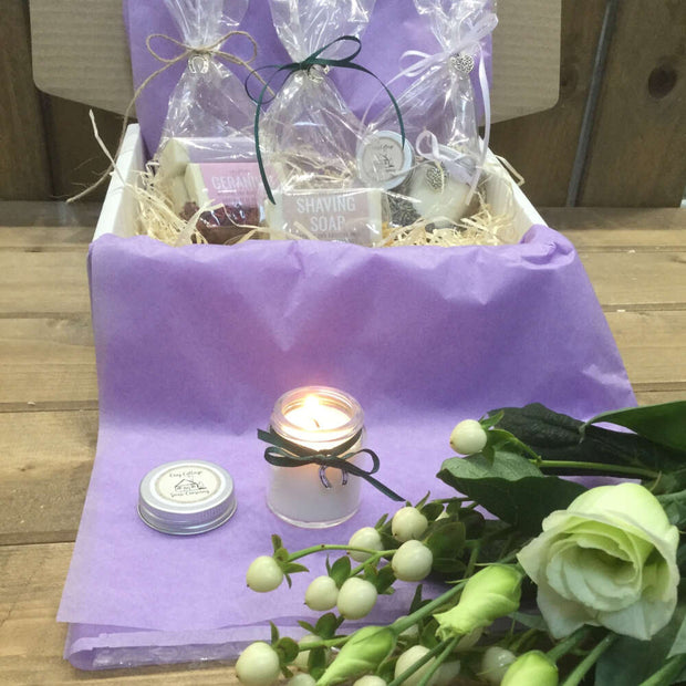 handmade candle burning in front of handmade wedding gift box