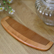 natural bamboo hair comb on a wooden table