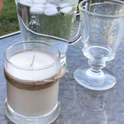 large lemongrass candle on an outdoor table in summer