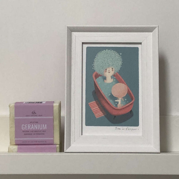 cooperillo framed print of a poodle in a bath next to a lady with poodle-style bubbles in her hair 