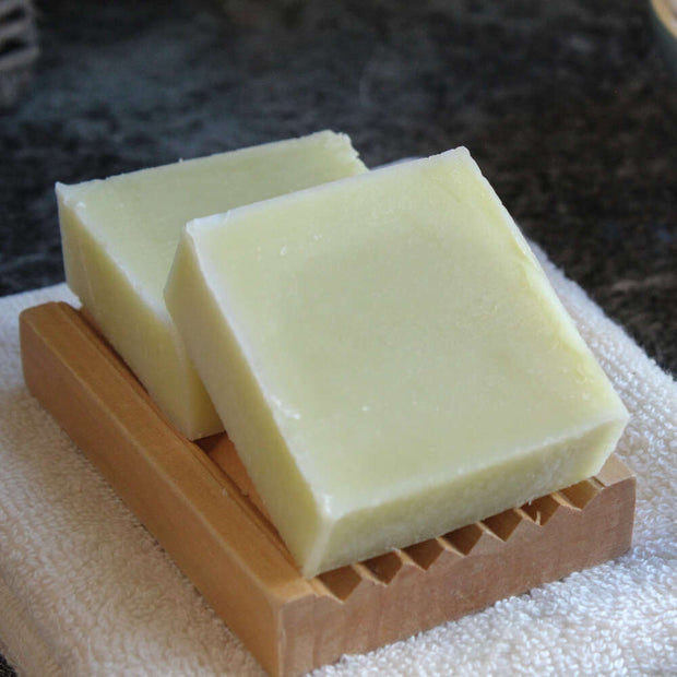 unwrapped natural soap bar stacked on corrugated natural soap dish