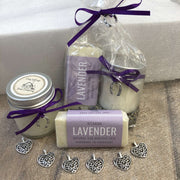 lavender travel soap and soy wax candle in biodegradable packaging bundle with purple ribbon