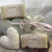 moisturising shea butter travel soap and purple petals in biodegradable packaging with pink ribbon and love hearts