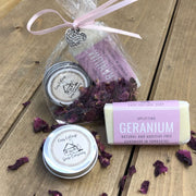 geranium handmade travel soap bar with lip balm in biodegradable packaging with petals tied with a pink ribbon